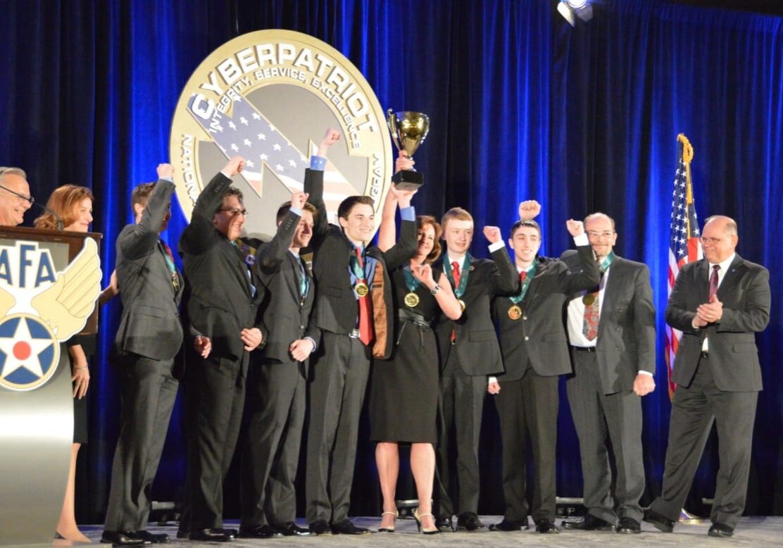 Team hoisting trophy