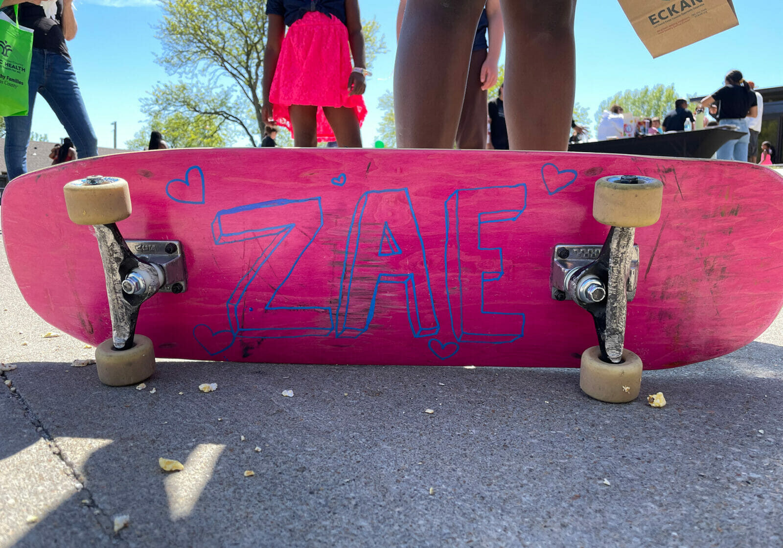A pink skateboard with the letters "ZAE" painted on. In Lawrence, Kansas local community and skate leaders compiled their gently used extra parts to give kids who live in low-income housing a chance at skate culture.
