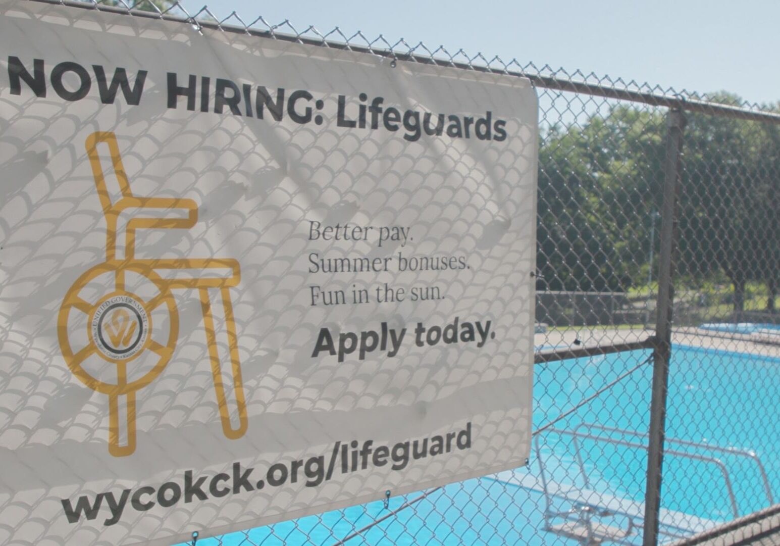 A "now hiring" sign at Parkwood Pool in Kansas. City, Kansas