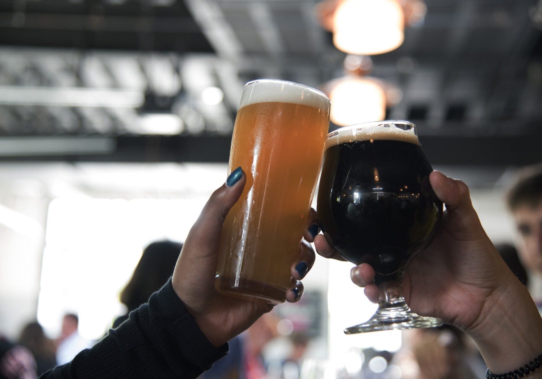 People toasting two beers.