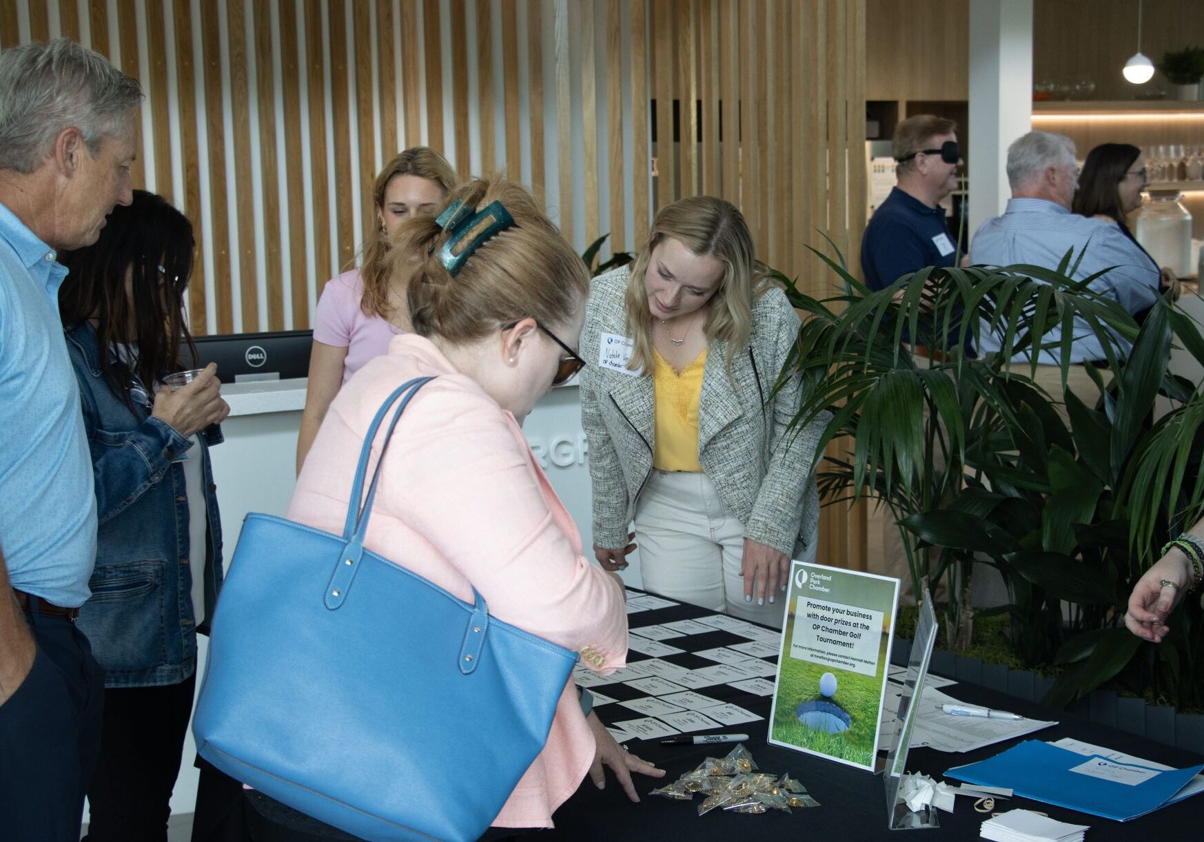Attendees check in for the "Love, Kansas" local kickoff hosted by the Overland Park Chamber of Commerce on July 11, 2024.