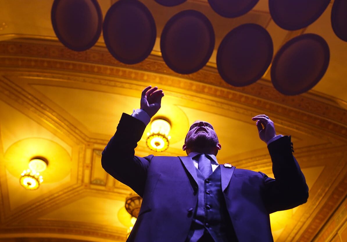 Artistic Director, Dustin Cates leads the Heartland Men's Chorus during a rehearsal on Thursday, December 3rd at The Folly Theater for their Holiday Concert. (Photo: Jim Barcus)