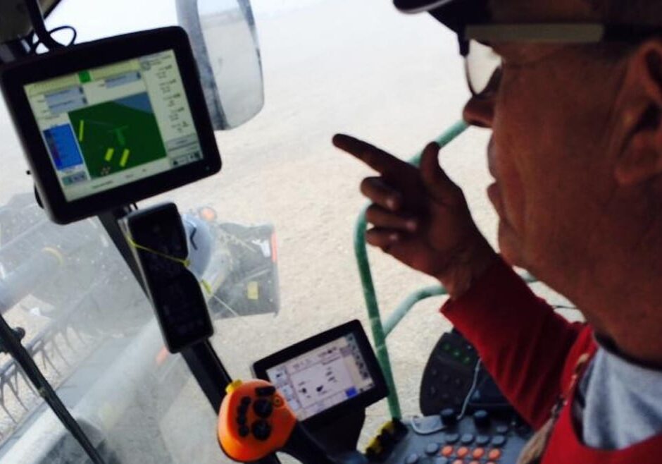 Blake Hurst, president of the Missouri Farm Bureau, in the cab of his combine, harvesting soybeans on his family's northern Missouri farm. He's watching satellite monitors that show yields, moisture content and fertilizer use. (Photo: Peggy Lowe | Harvest Public Media)