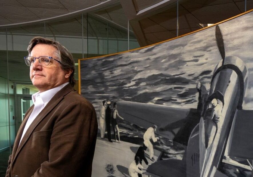 Mark Spencer, new arts program coordinator for the Kansas City Aviation Department, with “Tingmissartoq,” by Christopher Brown (shown behind him), created in 2000 for the KC Aviation Department building.