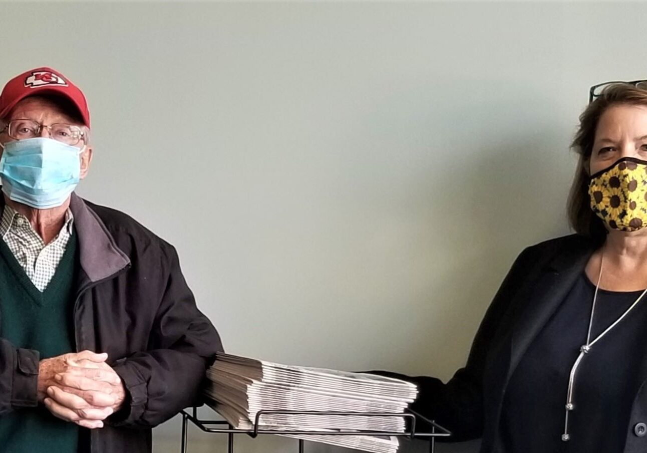 Sales director Dwight Barrett and publisher Kathy Feist in their newspaper office in Martin City.
