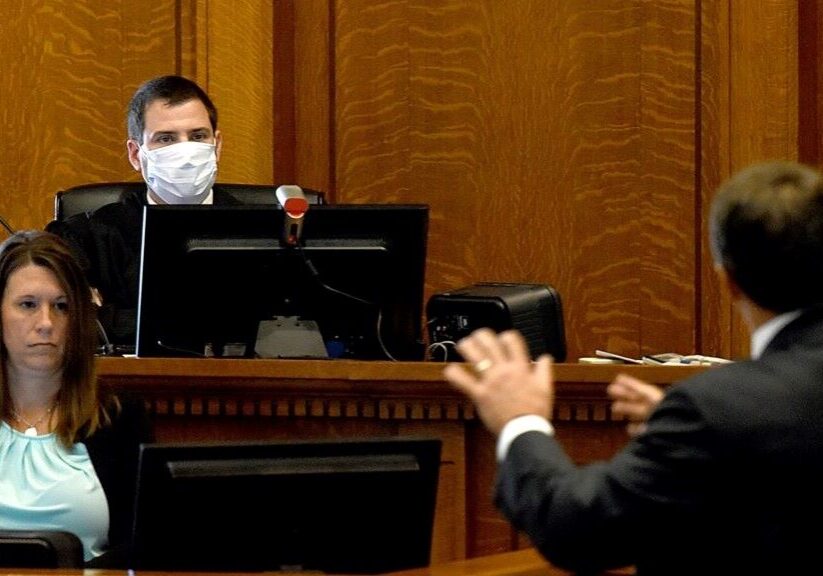 Boone County Circuit Judge Brouck Jacobs, center, listens to opening statements Tuesday as Solicitor General John Sauer argues for an order blocking mask rules in public schools.