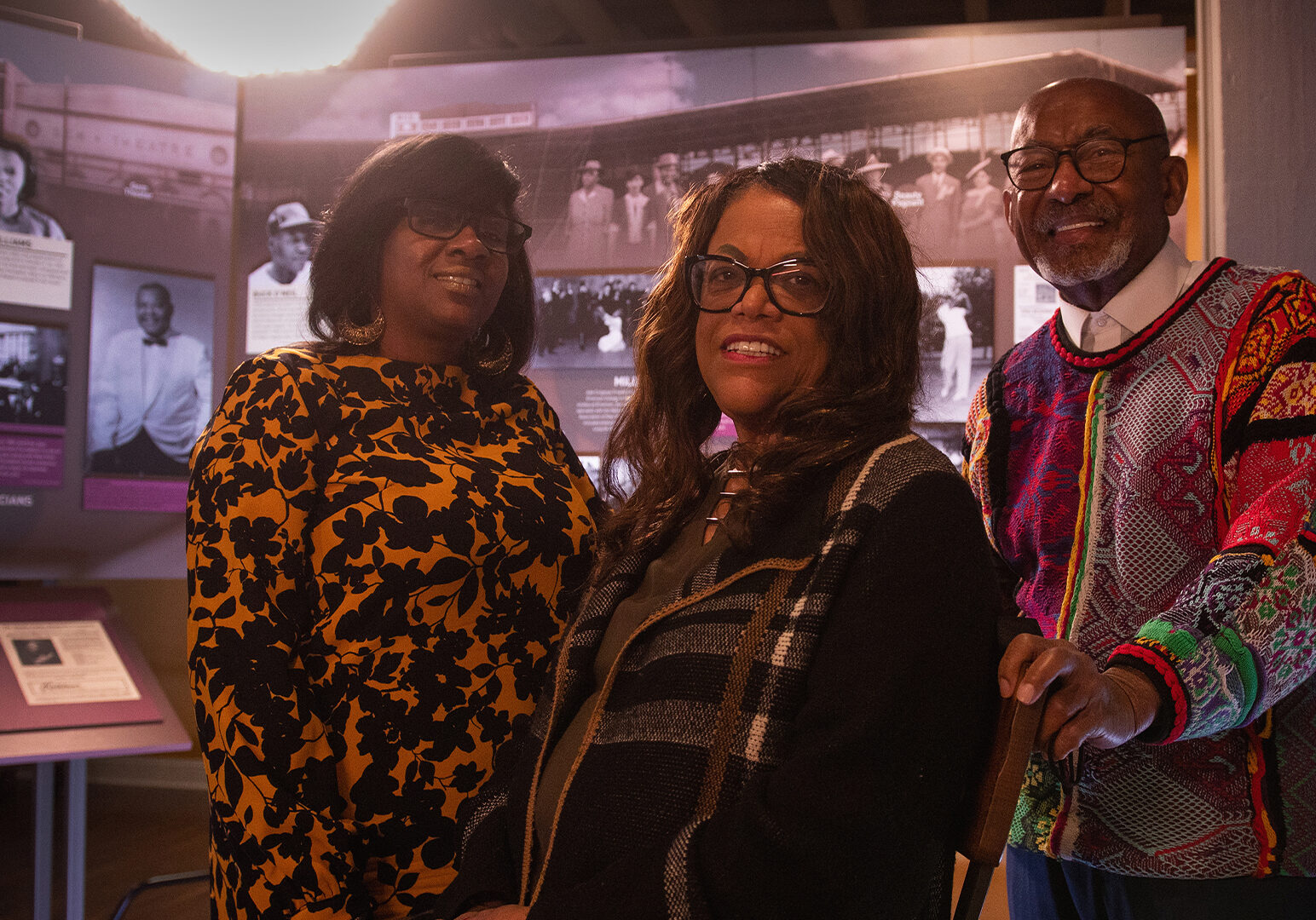 Two Black women and man at museum
