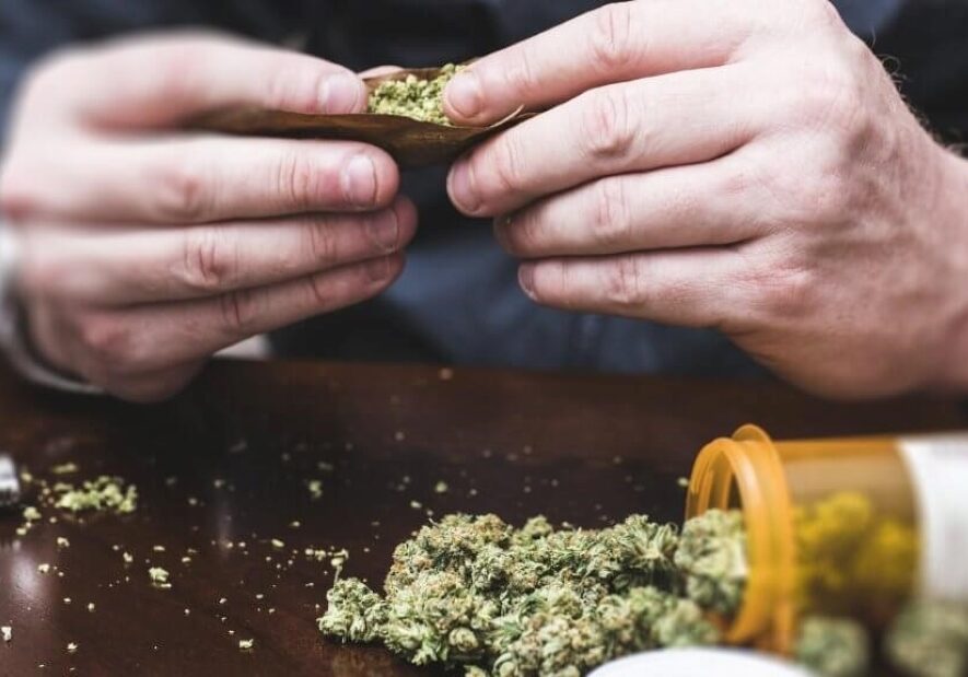 Man rolling a joint of medical marijuana.