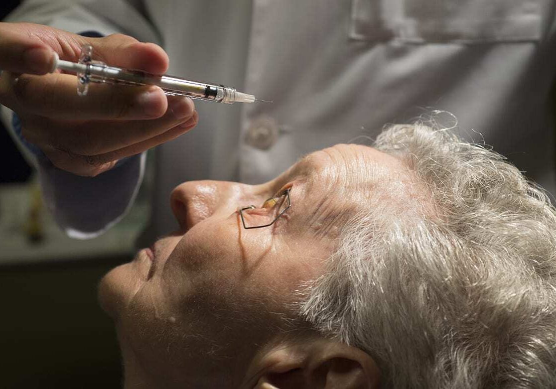 Dr. Ajay Singh, a retina specialist at The University of Kansas Eye Clinic in Prairie Village, prepared to inject Phyllis Johnson of Topeka with a drug that treats a condition where abnormal blood vessels leak fluid or blood into the region of the macula, which is in the center of the retina.