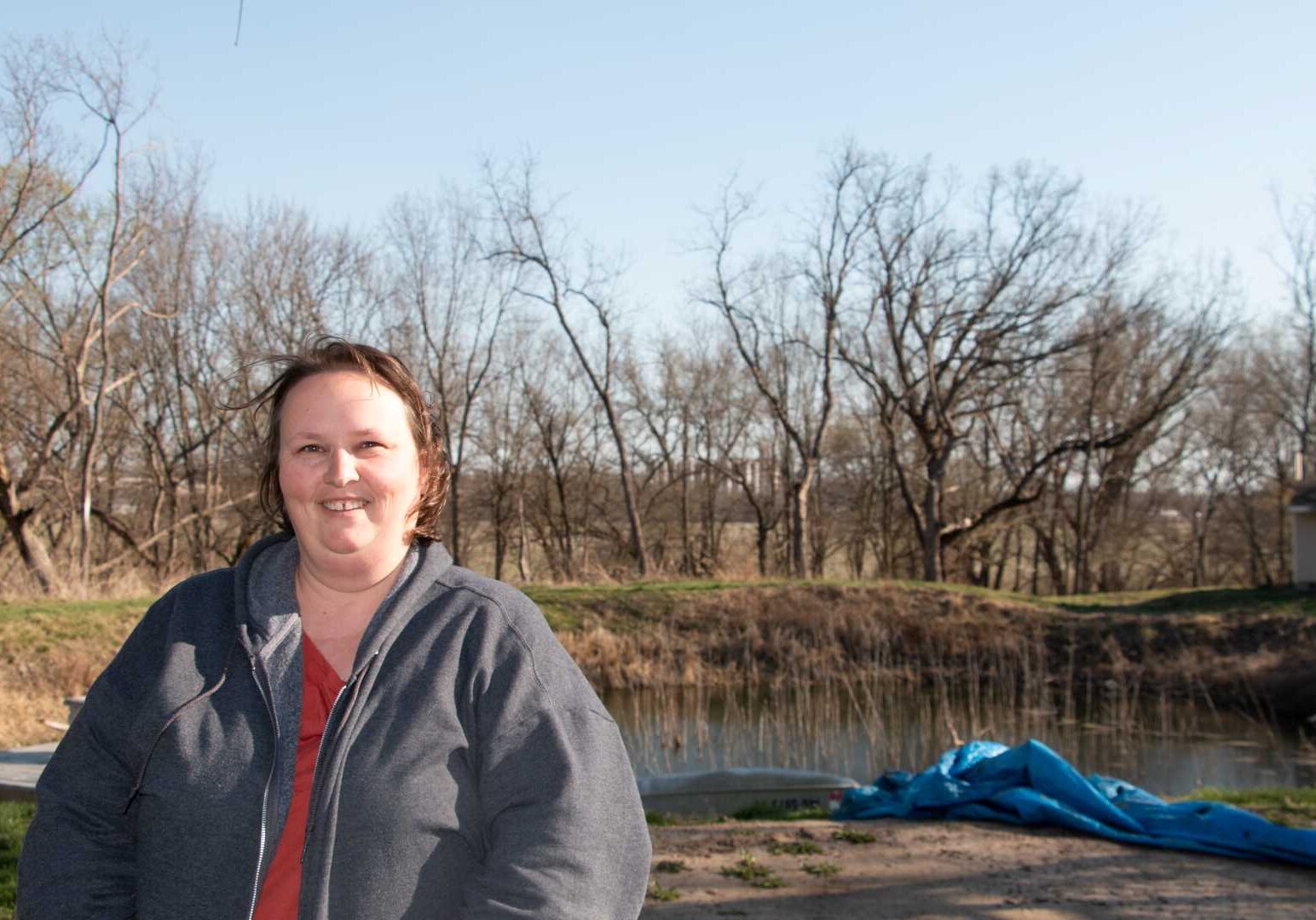 Meagan Black stands in front of the trees that block the tower on top of the grain elevator in Paola, Kansas, on March 29,