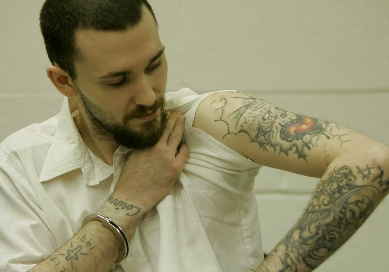 Michael Tisius shows his tattoos during an interview at Potosi Correctional Center.