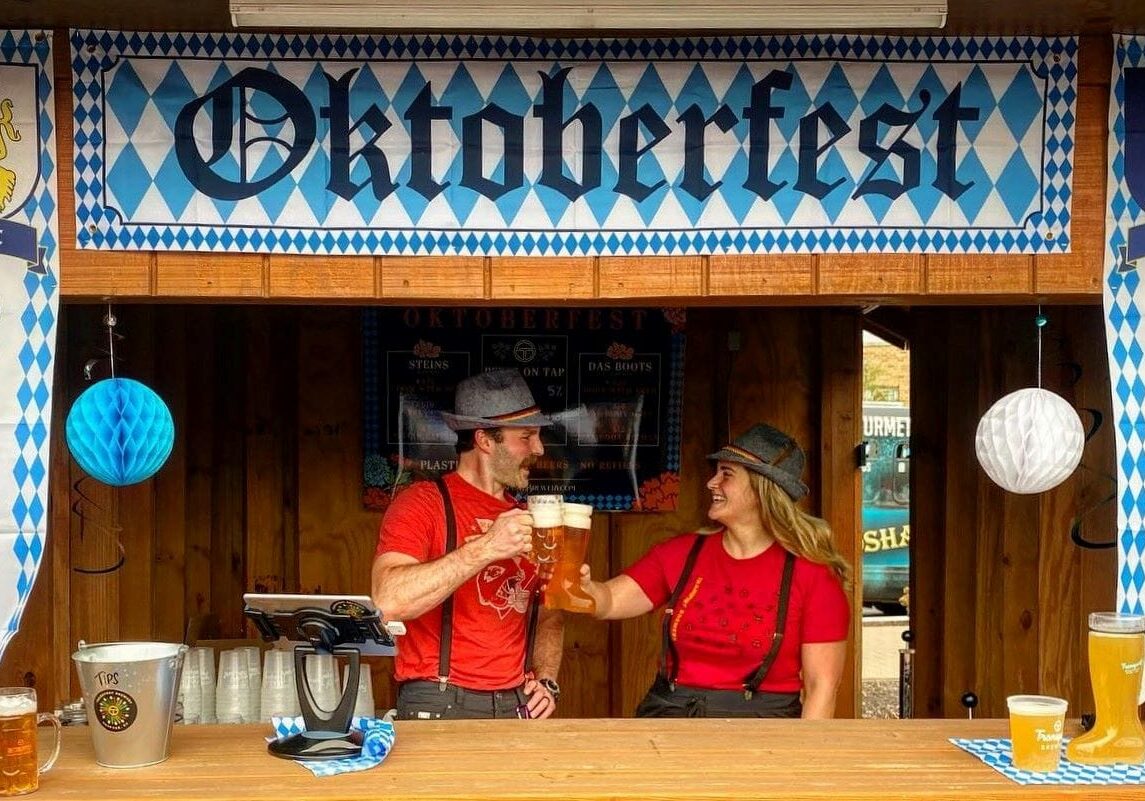 Two bartenders toasting Oktoberfest.