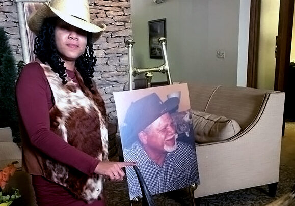 Oralee holds photo of her father, Warren Watkins Jr.