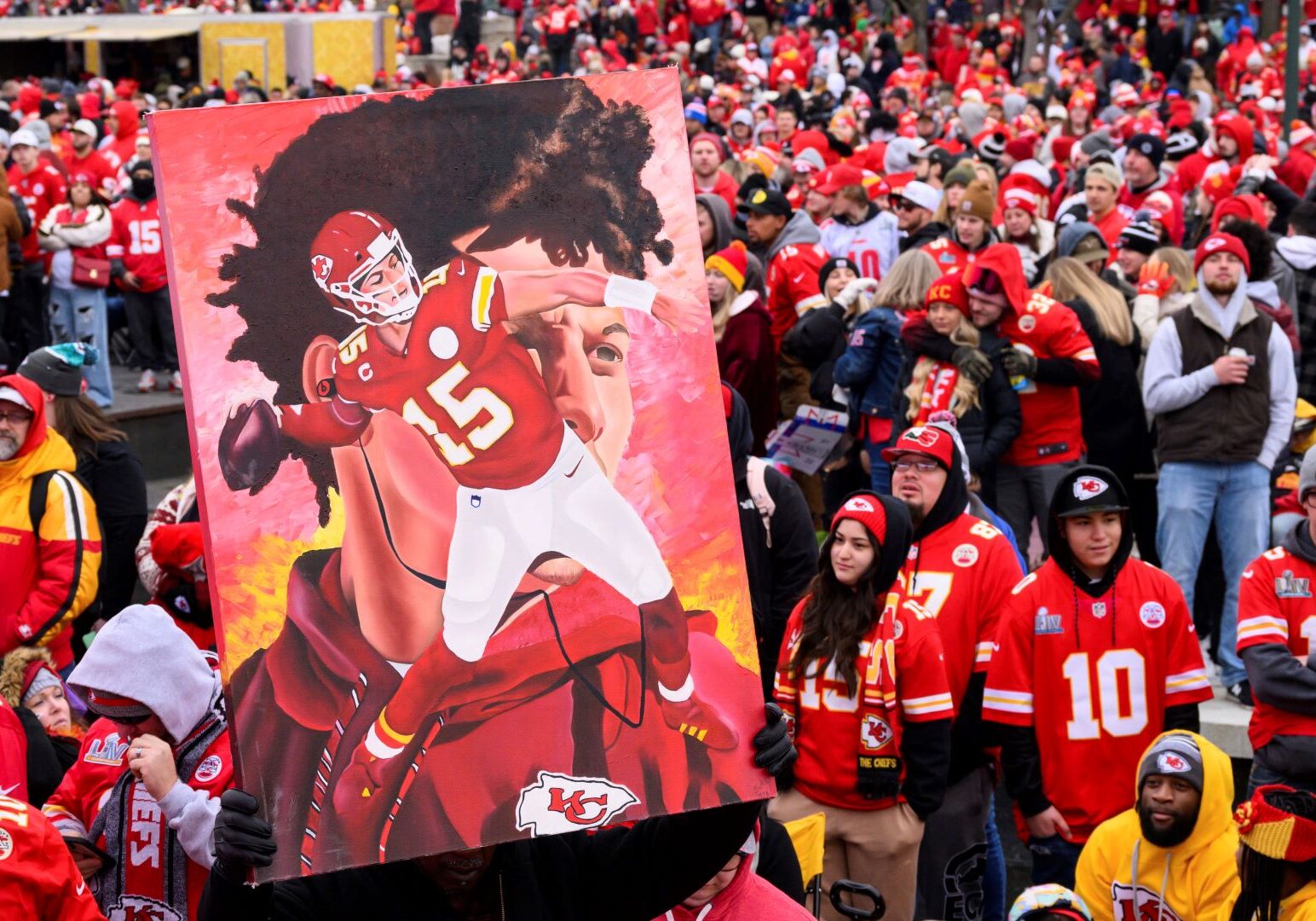 A man carries a portrait of Kansas City Chiefs quarterback Patrick Mahomes through the crowd during the Chiefs' victory celebration and parade in Kansas City, Mo., Wednesday, Feb. 15, 2023. The Chiefs defeated the Philadelphia Eagles Sunday in the NFL Super Bowl 57 football game.