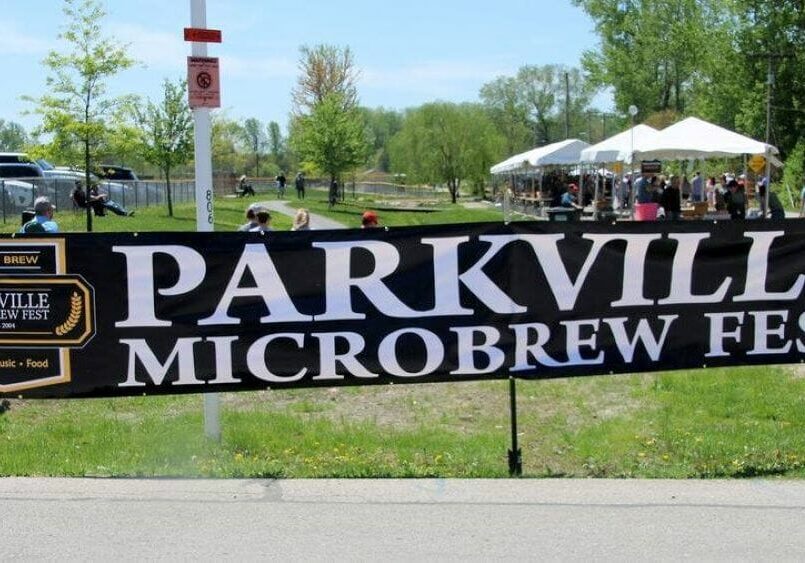 Entrance sign for the Parkville Microbrew Fest with English Landing Park in the background.