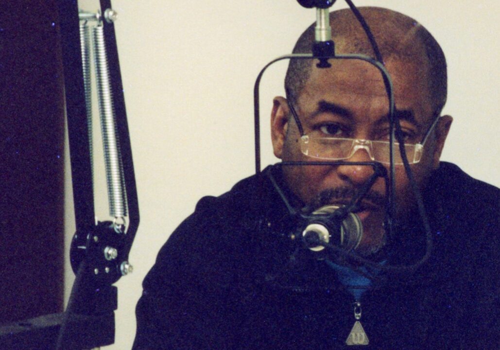 Carl Boyd speaking into a radio microphone.