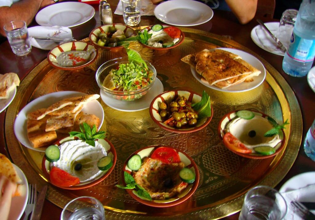 This photo shows food commonly served during Ramadan, including an entree of beef or chicken, a salad, and rice.