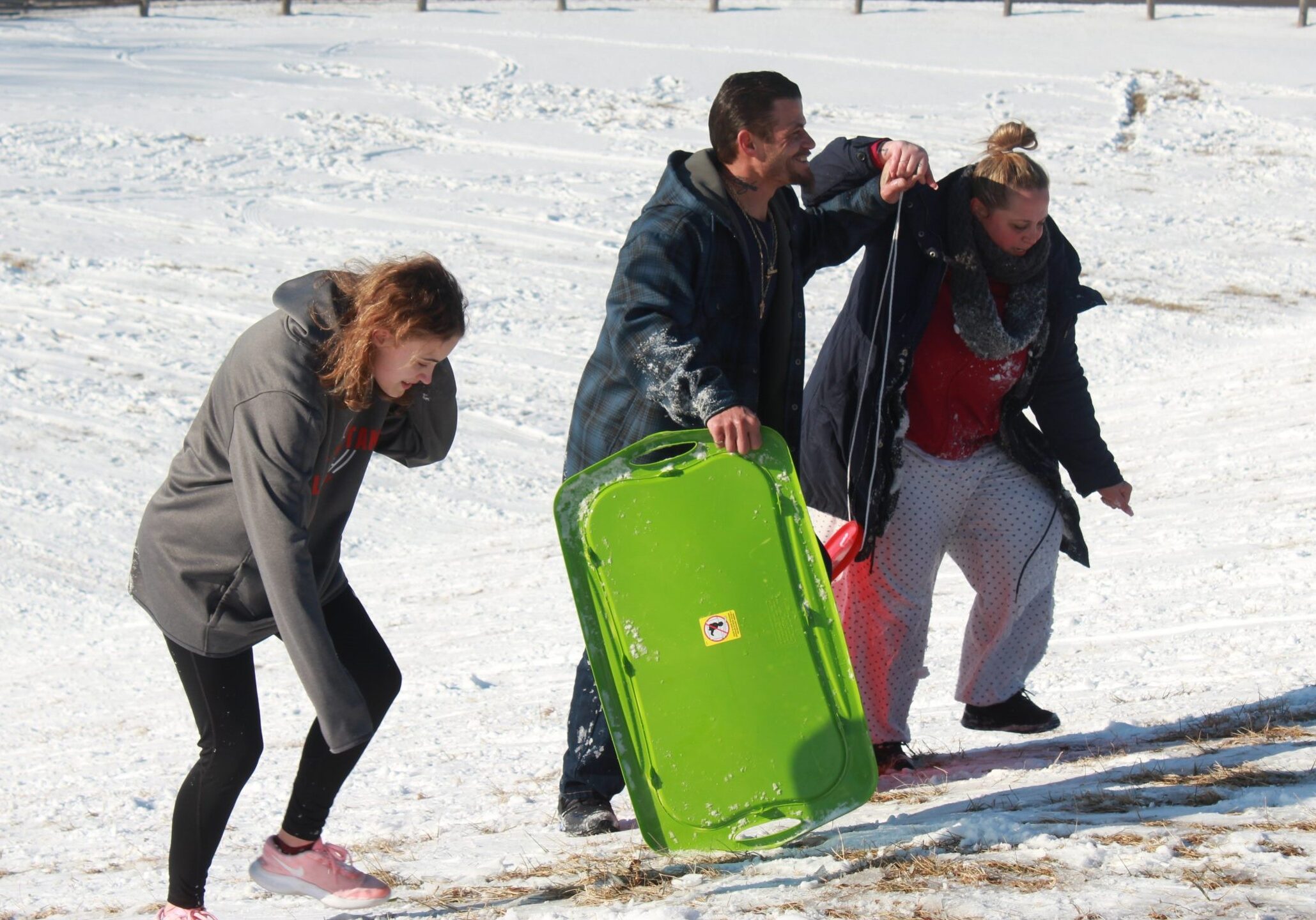 Despite the severe cold, families from around Lyon County gather Wednesday at the Prairie Street bridge hill in Emporia for sledding.