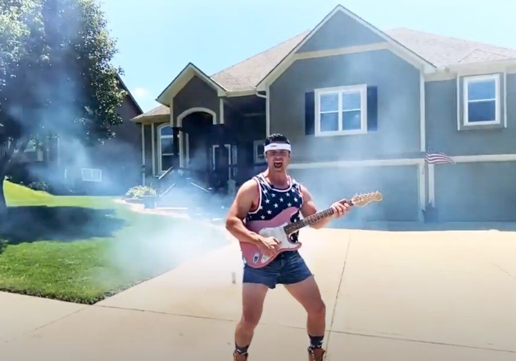 Realtor Jason Rains jams out in front of a home for a patriotic July 4th video.