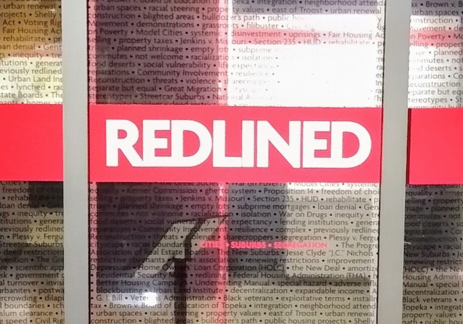 The doors to the Johnson County Museum exhibit: "Redlined: Cities, Suburbs, and Segregation."