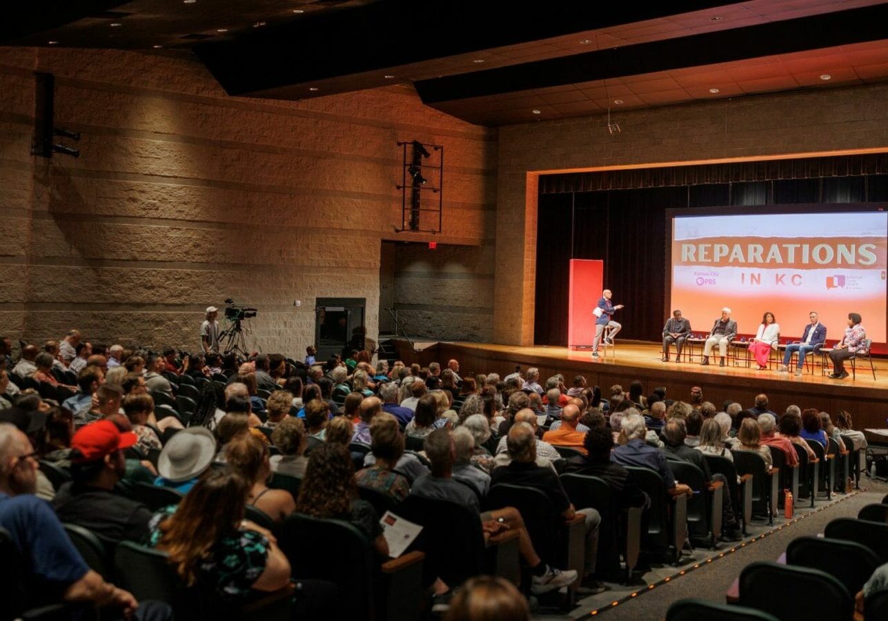 Hundreds of Kansas Citians gather at University Academy for a town hall discussion on reparations in Kansas City.