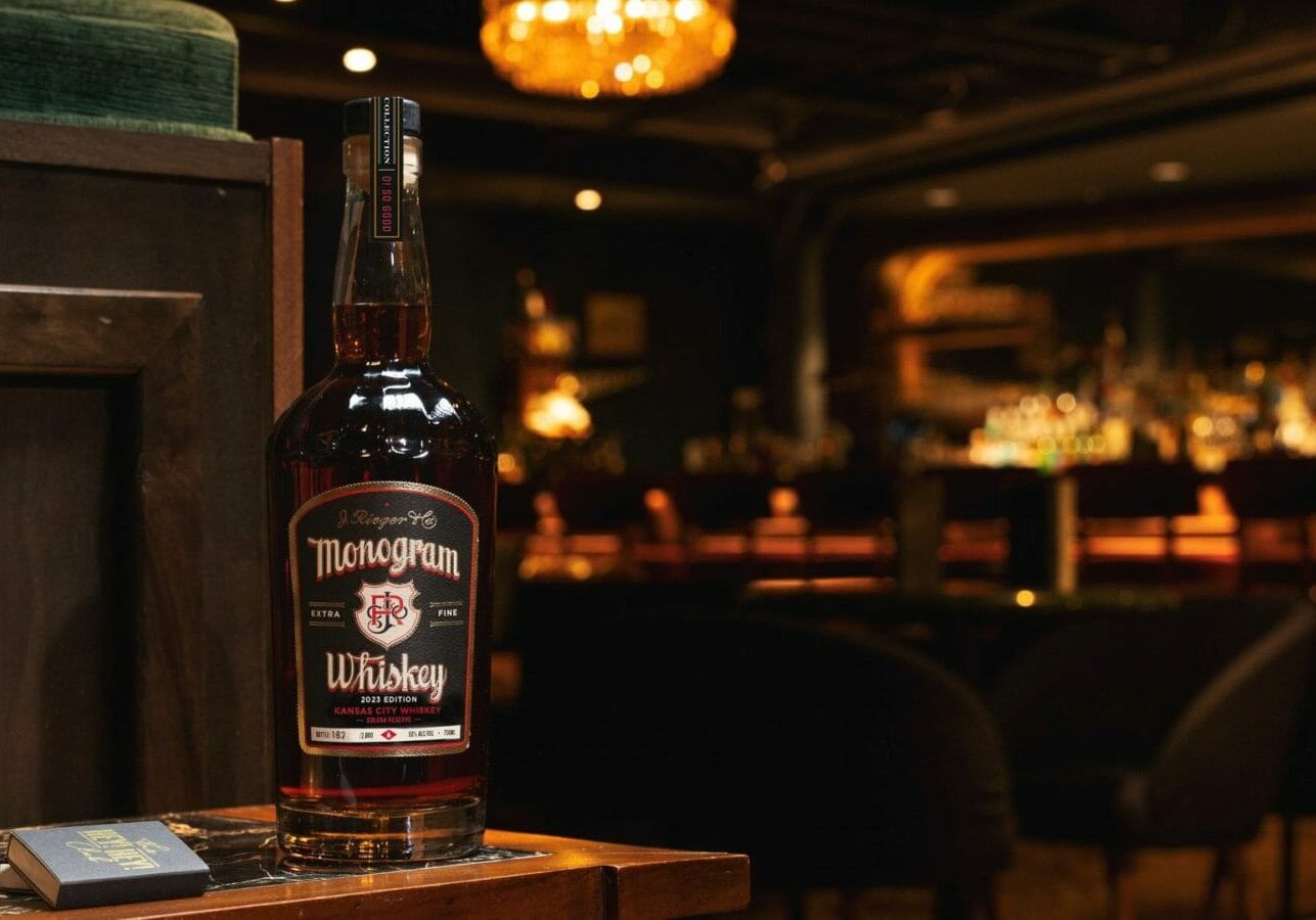 A bottle of J. Rieger & Co.'s Monogram Whiskey in a bar.