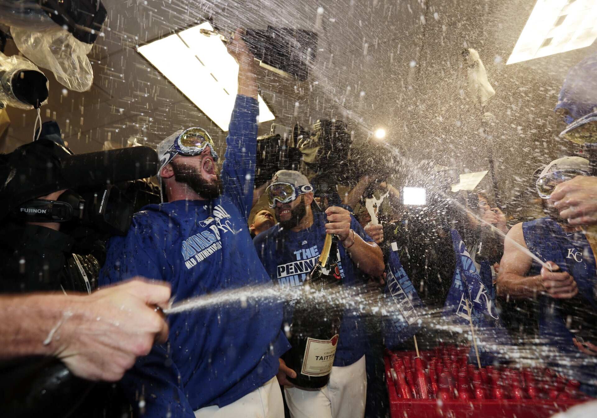 Kansas City Royals celebrates their 4-3 win against the Toronto Blue Jays in Game 6 of baseball's American League Championship Series on Friday, Oct. 23, 2015, in Kansas City, Mo. (AP Photo/Charlie Riedel)
