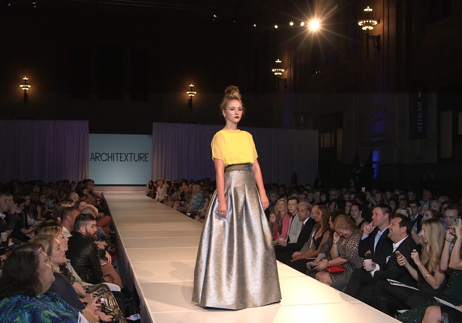 A runway model walks at KC Fashion Week.