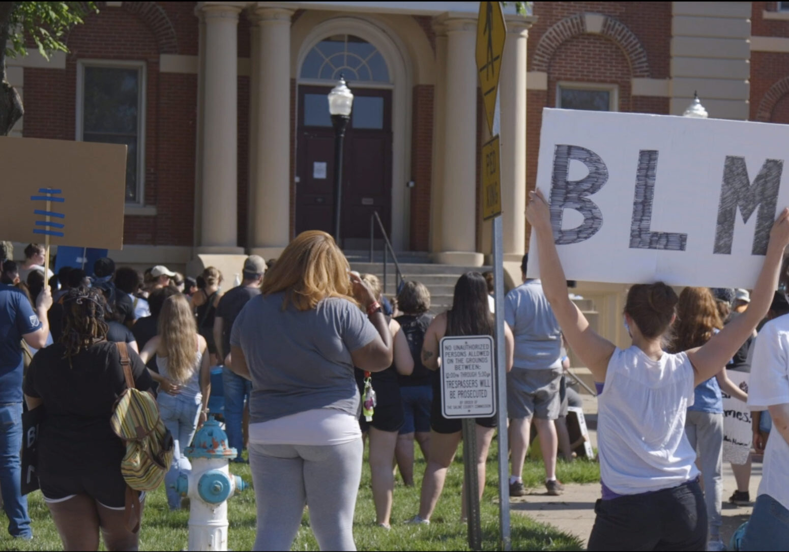 Protesters stand on the north lawn of the Saline County Courthouse in Marshall, Missouri on Sunday, June 7, 2020.