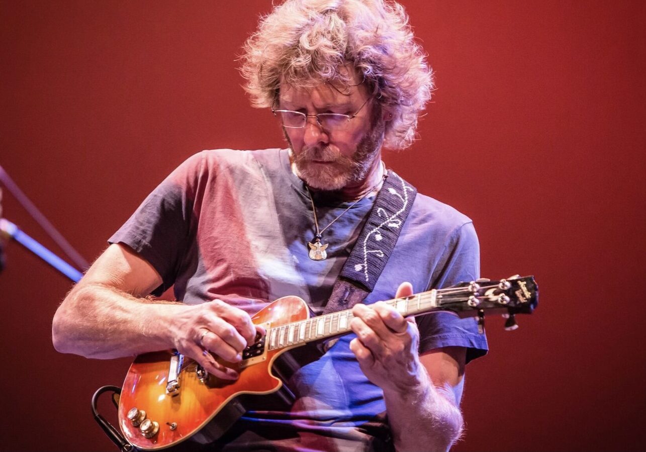 Bluegrass artist Sam Bush plays the mandolin on stage.