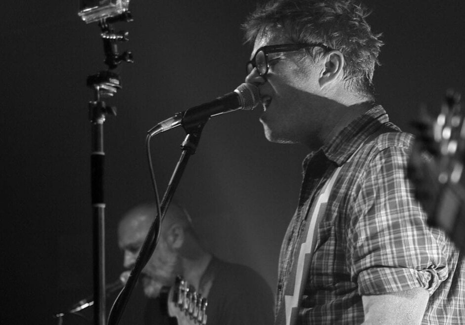 A man singing on stage.