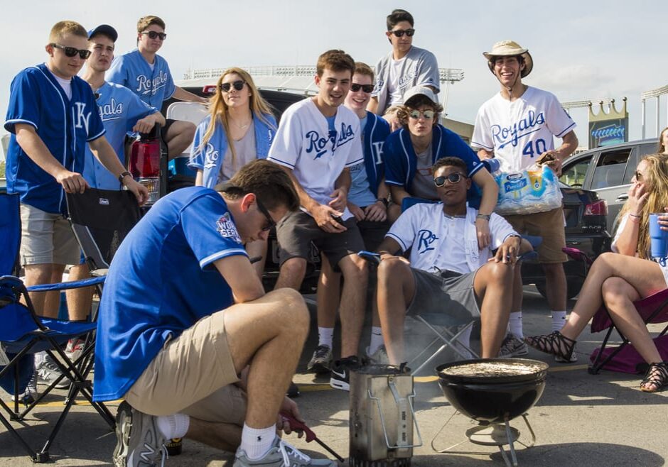 Tailgaters light a charcoal fire at Kauffman Stadium