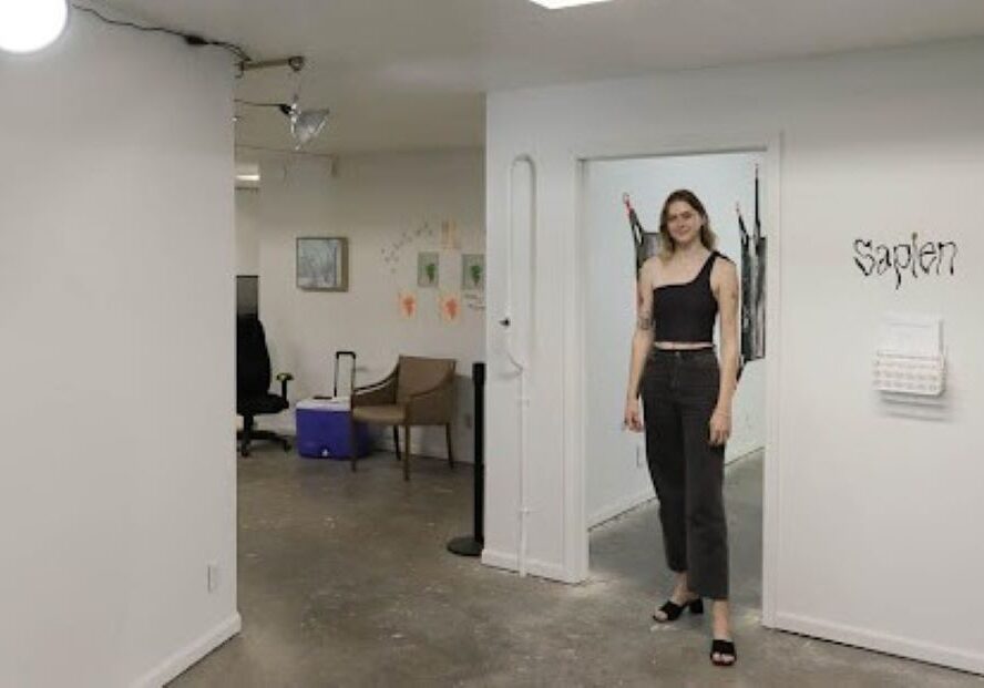 Co-curator RJ Junger stands in the foyer inside Sapien Gallery.
