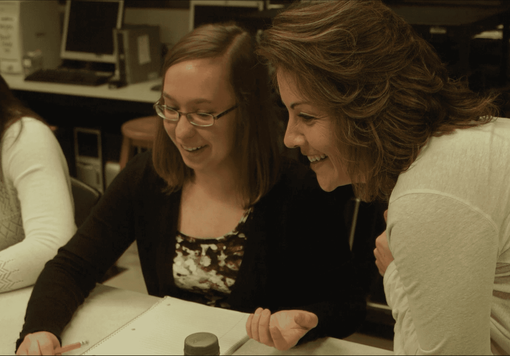 Angie Klein helps one of her students with coding.