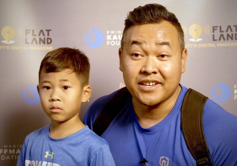 a man and his son talking on camera