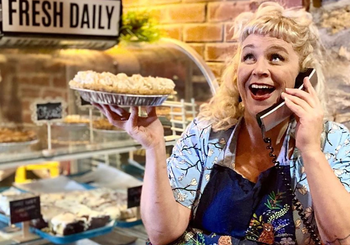 Meg Heriford, owner of Ladybird Diner, holds a pie and poses