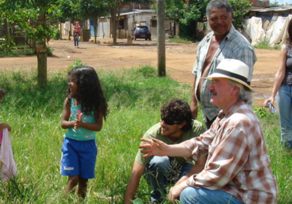 Kansas artist Stan Herd working with area youth and others on one of his prior trips to Brazil's favelas.