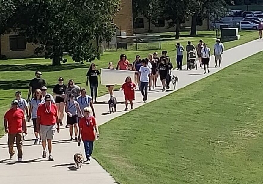 People gather for a suicide prevention and awareness walk in Hays in 2018.