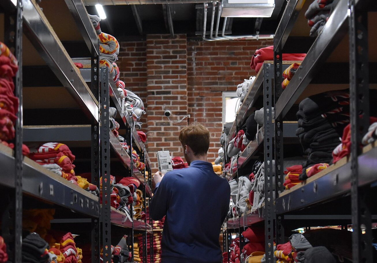 A member of the Charlie Hustle team scans the Kansas City apparel brand's stock room for an item bound for an online order.