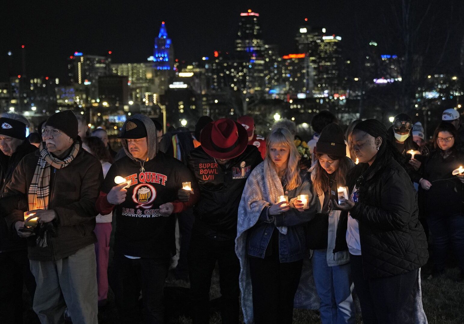 People attend a candlelight vigil for victims of a shooting at a Kansas City Chiefs Super Bowl victory rally Thursday, Feb. 15, 2024 in Kansas City, Mo. More than 20 people were injured and one woman killed in the shooting near the end of Wednesday's rally held at nearby Union Station.