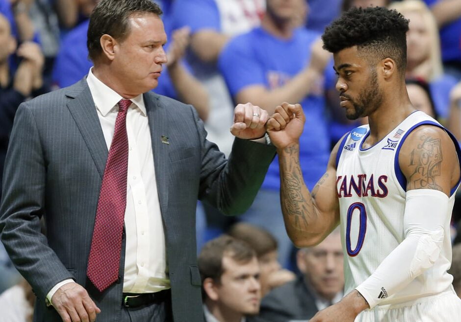 A basketball coach and player bump fists