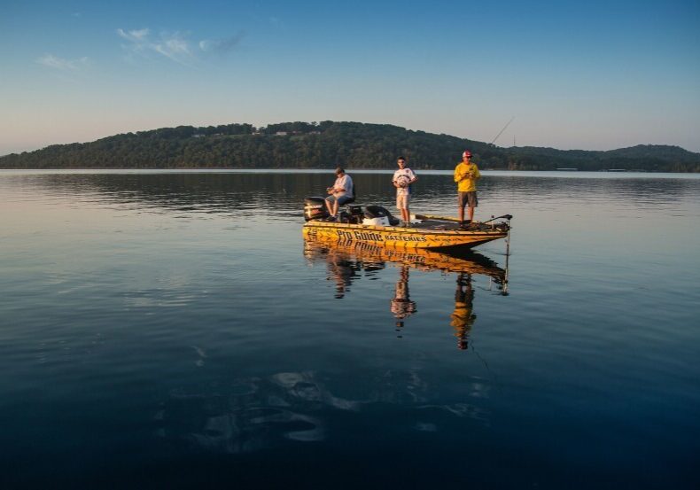 Three people fishing in a boat on Table Rock Lake.