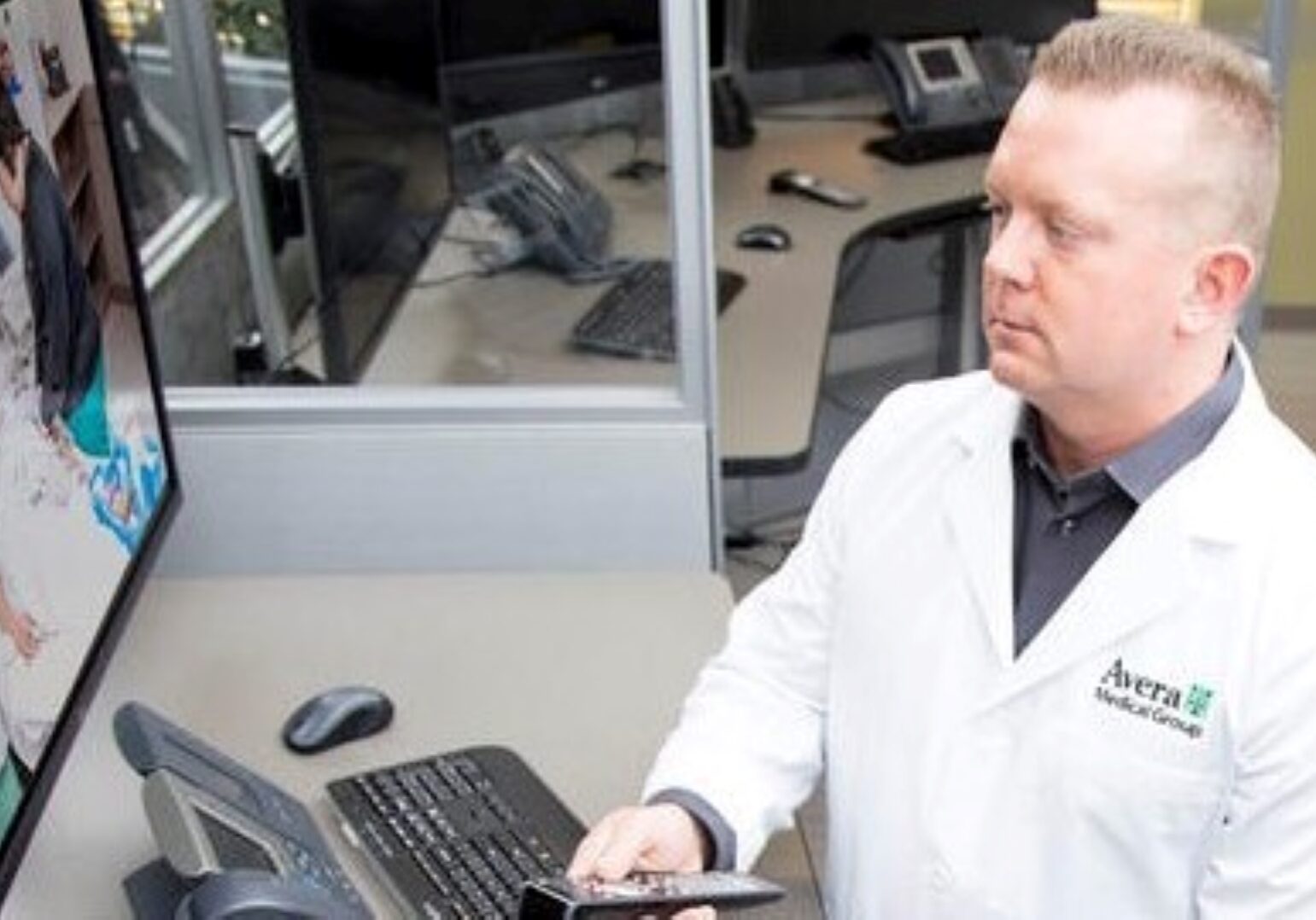 Brian Skow, an emergency room specialist, responds to a video call at Avera eCARE telemedicine center in Sioux Falls, South Dakota.