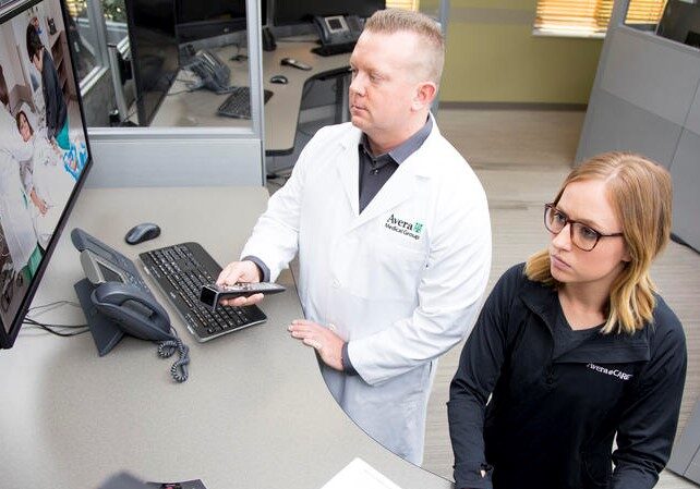Brian Skow, an emergency room specialist, and nurse Amanda Sandager respond to a video call at Avera eCARE telemedicine center in Sioux Falls, South Dakota.