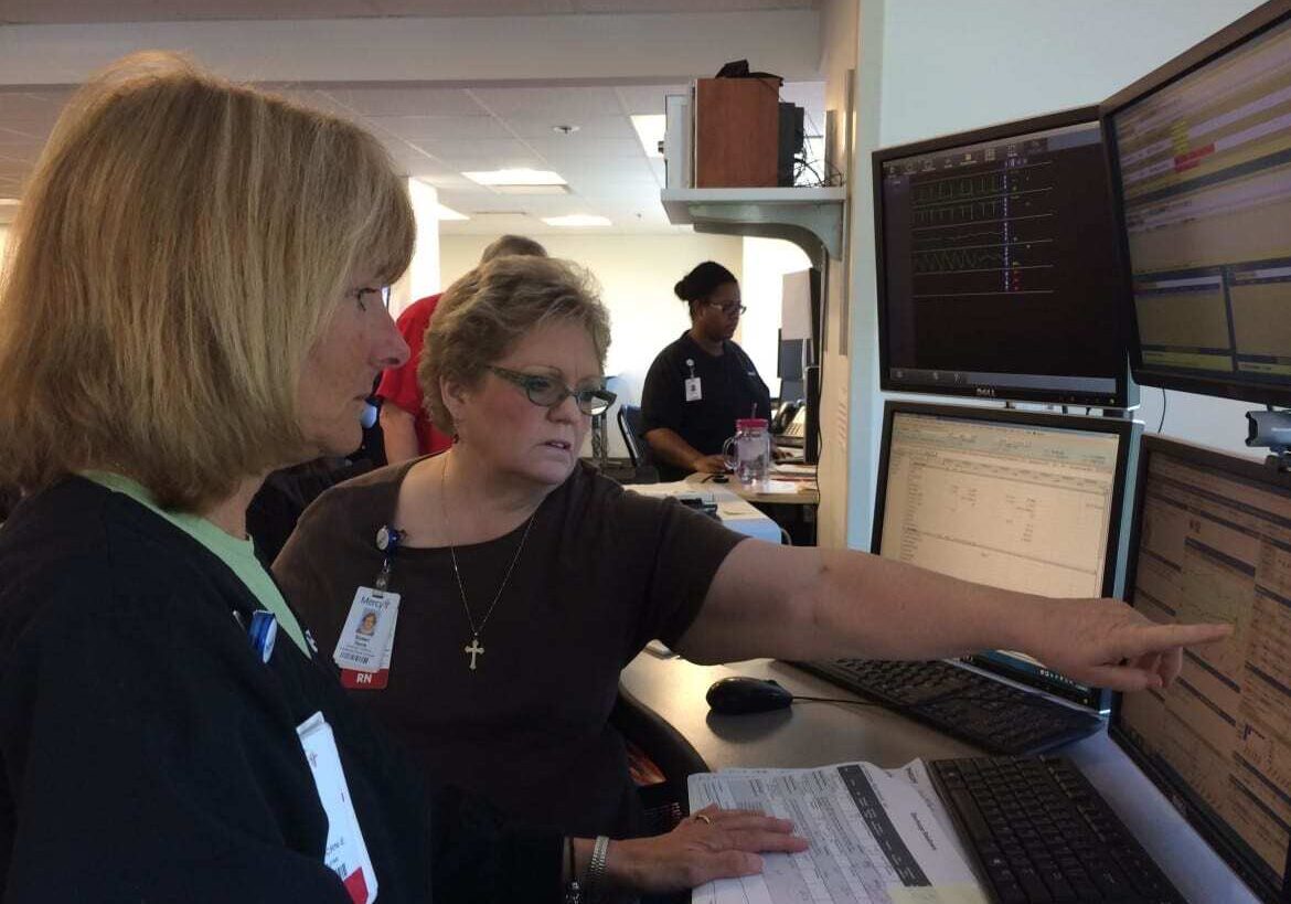 Nurses Patricia Wegener, from left, and Susan Davis at Mercy Hospital can monitor the condition of a patient who is miles away via the hospital's technology. (Photo: Alex Smith | Heartland Health Monitor)