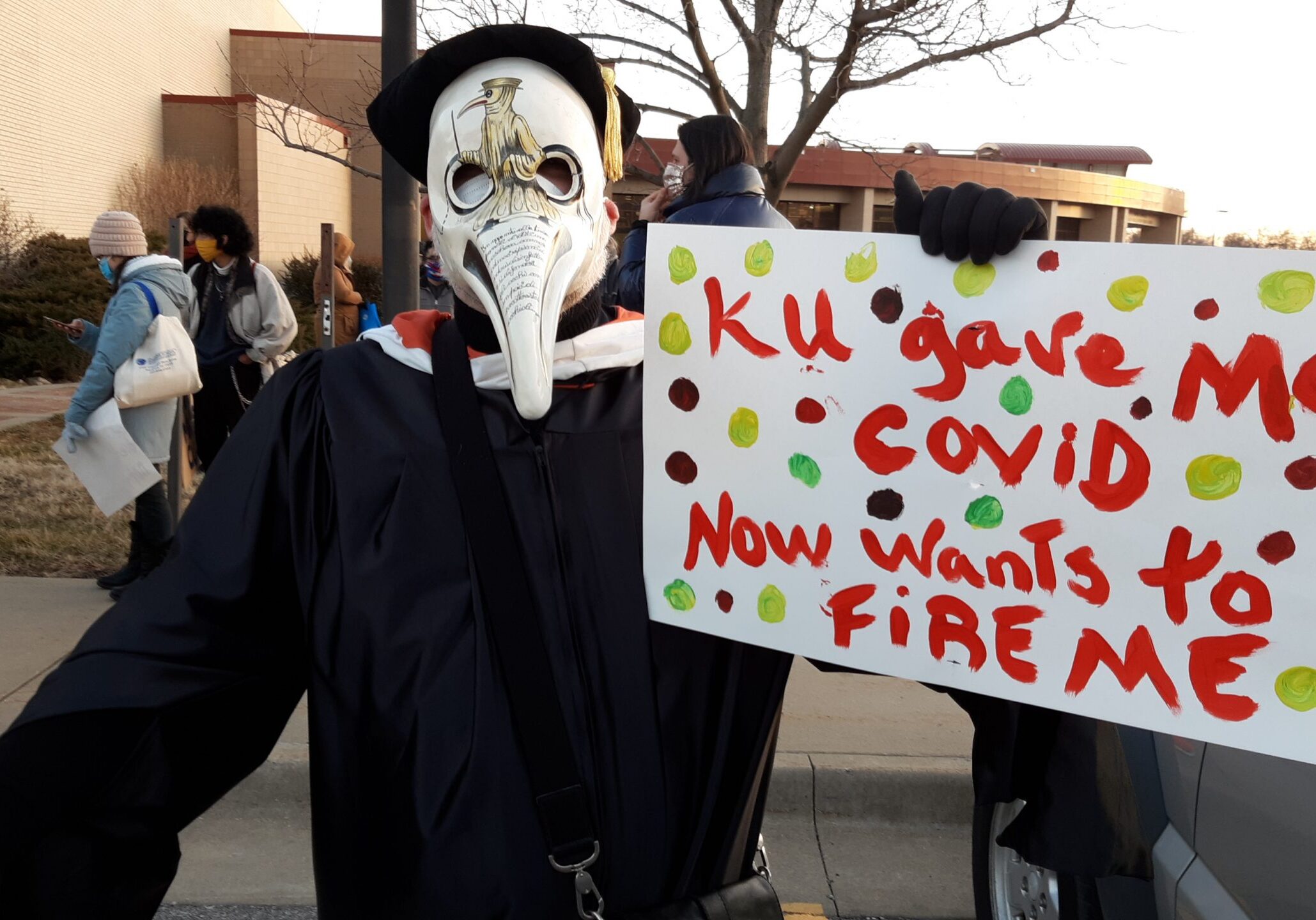 Gregory Cushman, an associate professor of environmental history at the University of Kansas, marched with faculty and students to raise awareness about potential damage of administration plans to downsize the staff and eliminate degree programs to address budget problems.