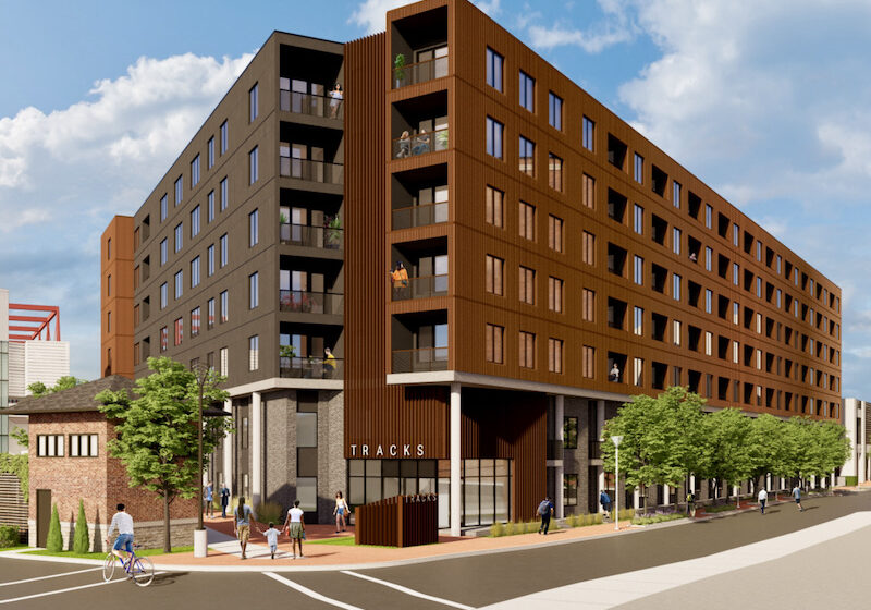 The new design of The Tracks apartment project, shown in this preliminary conceptual drawing, now has residences and landscaping (foreground) along 22nd Street instead of a blank garage. (Rendering by Helix)