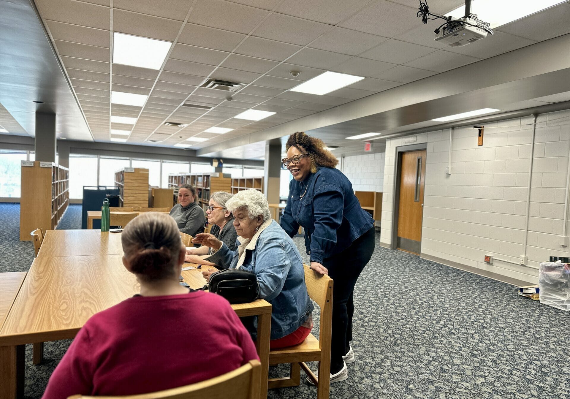 A crowd surrounds Kim Riley, parent and founder of the Transition Academy. For the past several years, her focus has been to build a network that better assists families whose children have developmental or intellectual disabilities find meaningful careers.