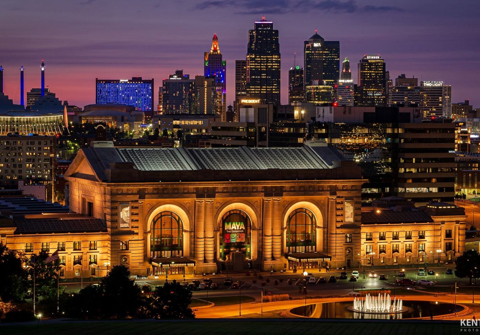 Union Station at night with the downtown skyline in the background.