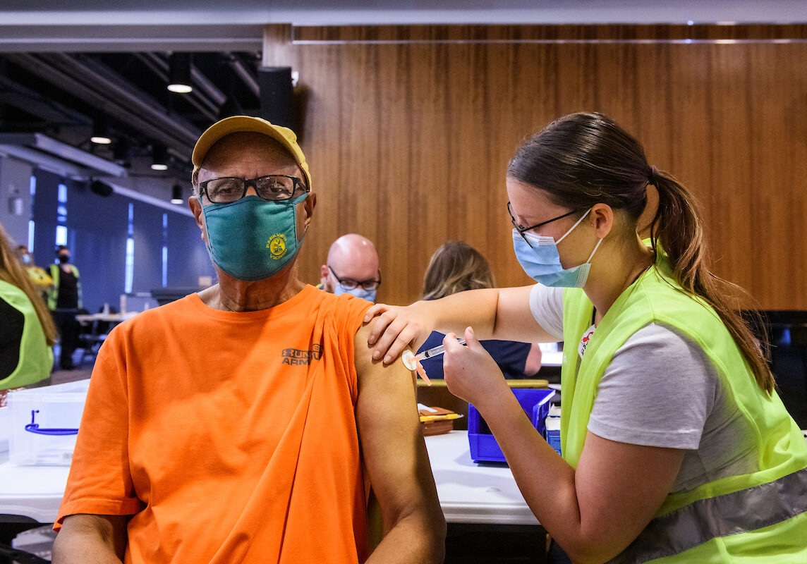 Earl Coleman receives his COVID-19 vaccine from MU Health Care staff nurse Paige Spry, RN, during MU Health Care’s vaccination clinic in the Walsworth Family Columns Club at Faurot Field in Columbia, Mo. on Thursday, Feb. 4, 2021.